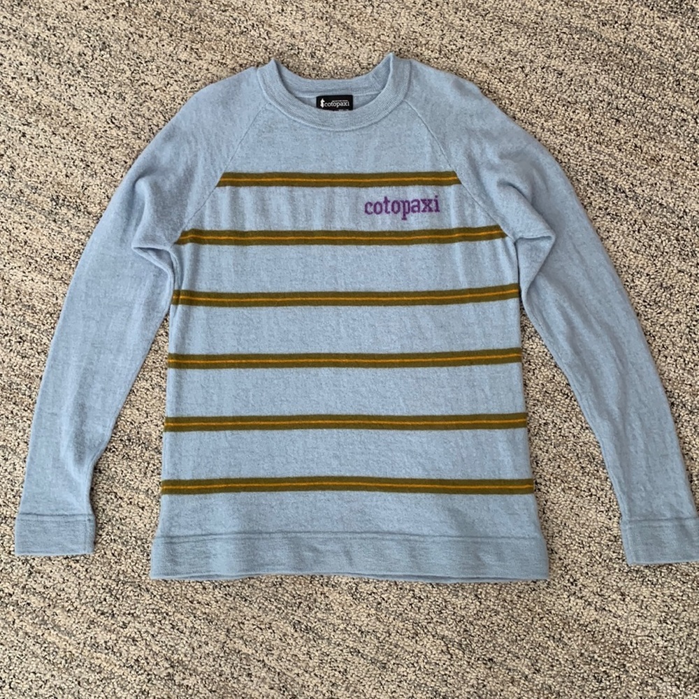 Cotopaxi light blue sweater with stripes.